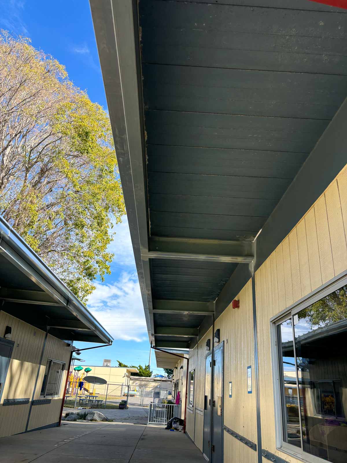 After: restored eave and fascia along the modular classroom walkway