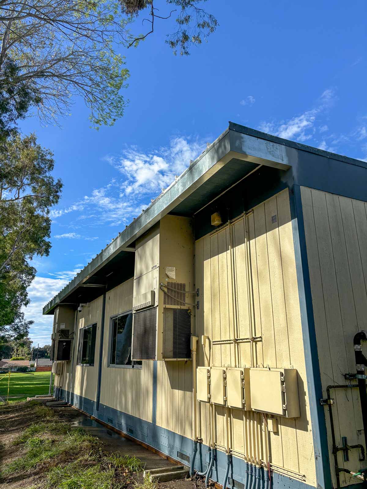 After: restored exterior wall and roof edge on a modular classroom