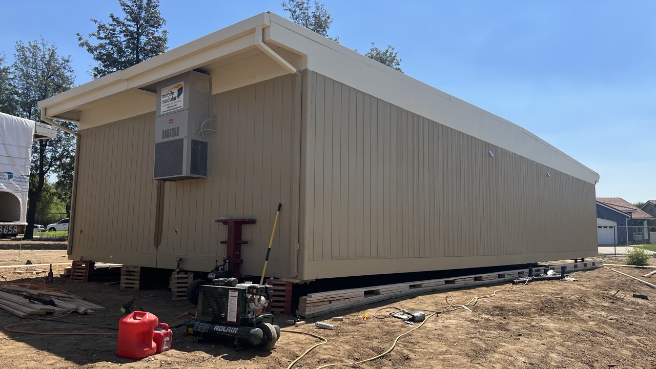 Completed modular classroom with new siding on site
