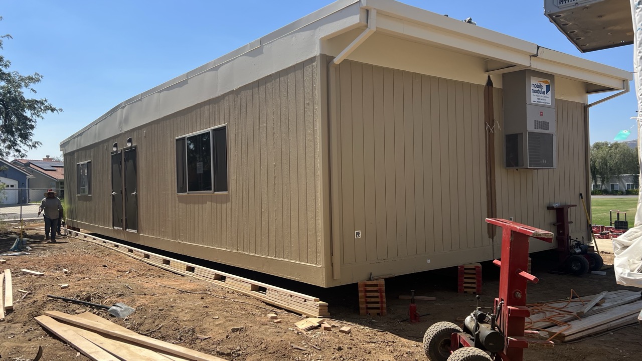 Modular classroom set on cribbing during installation