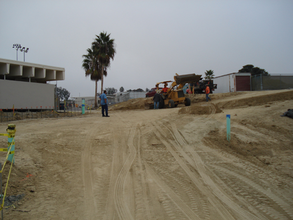 Crew and equipment working on the graded site pad
