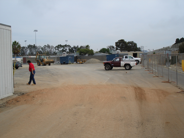 Work trucks staged on the graded site before installation