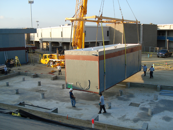 Modular restroom module suspended above its concrete piers