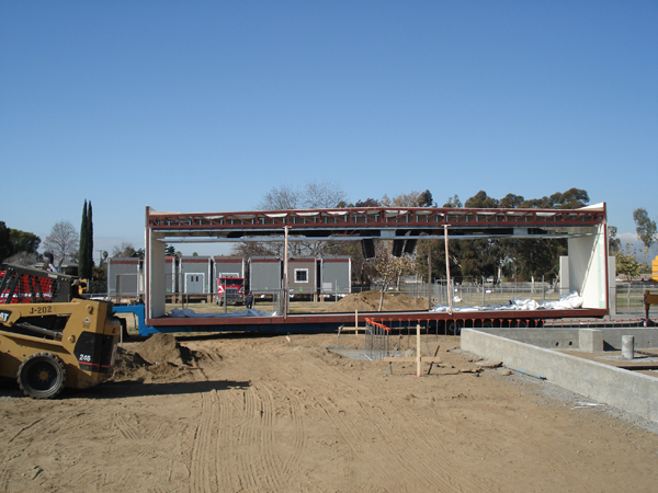 Modular building sections positioned on the foundation