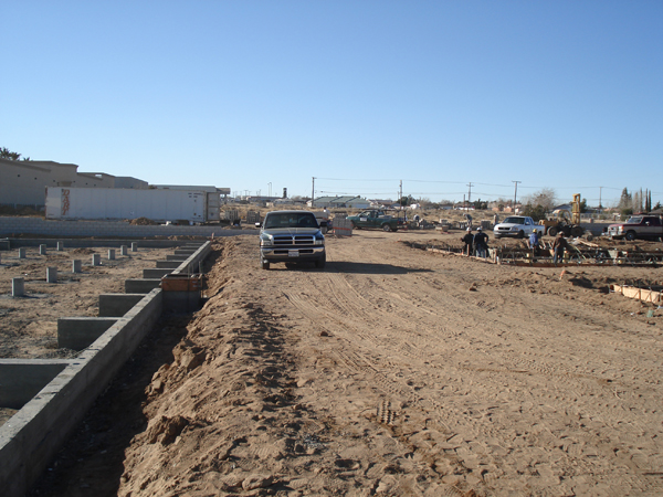 Foundation trench and footing forms across the building pad