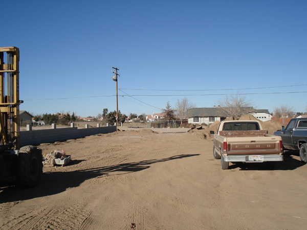 Graded dirt lot with equipment before the modular set