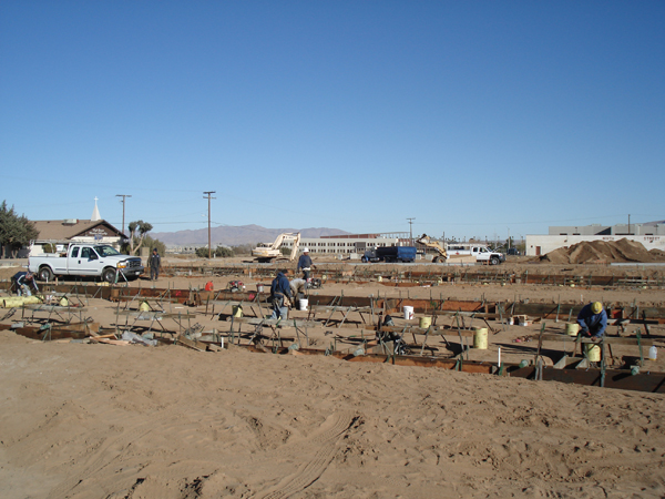 Crew working along the formed foundation footings