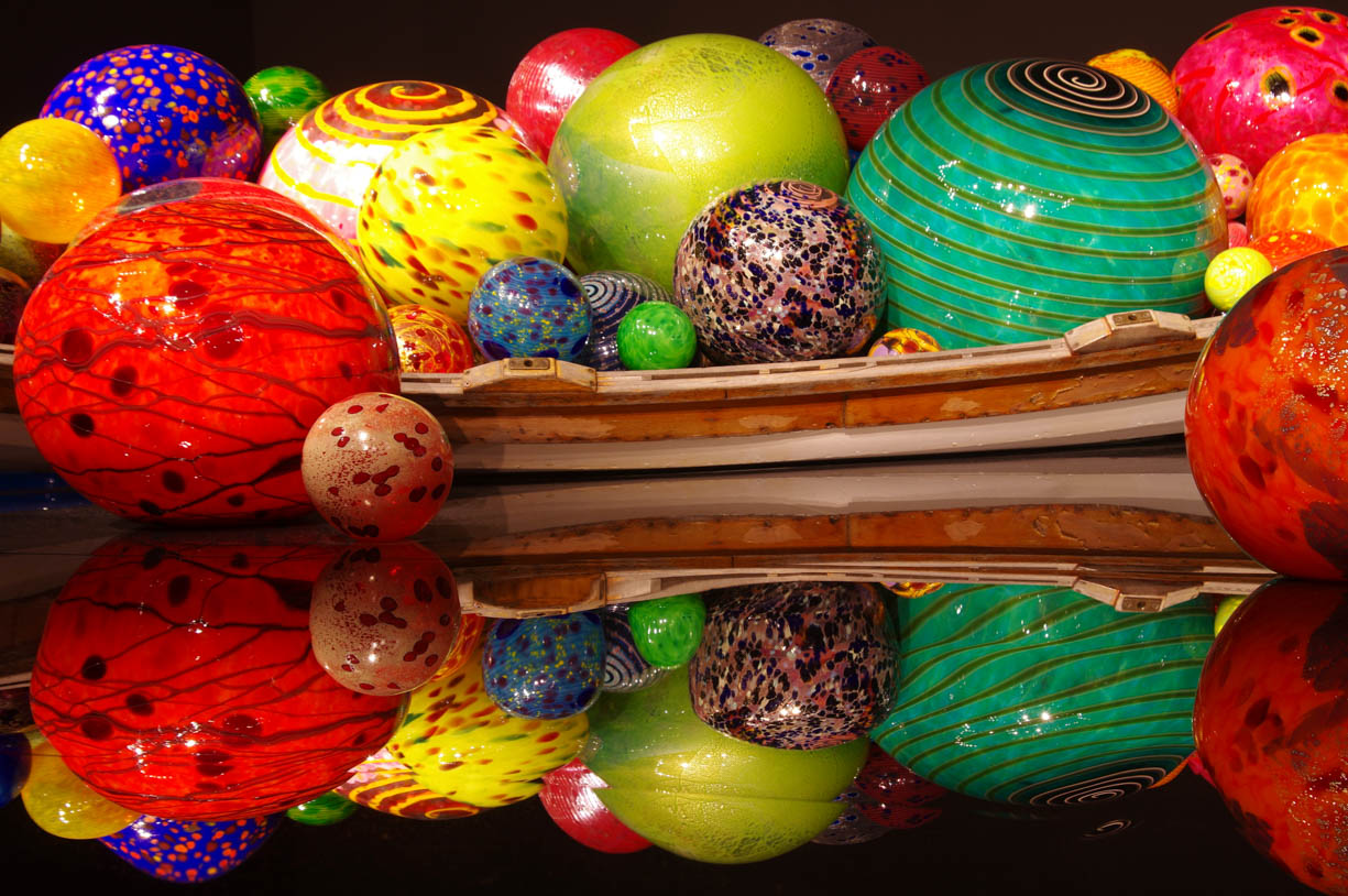The glass canoe is filled with glass balls in the Chihuly Garden and Glass in Seattle, Washington, USA. This scene can be viewed by standing in the second main room in Chihuly's Garden of Glass. This image was taken with a tripod to maximize viewing and resolution quality.