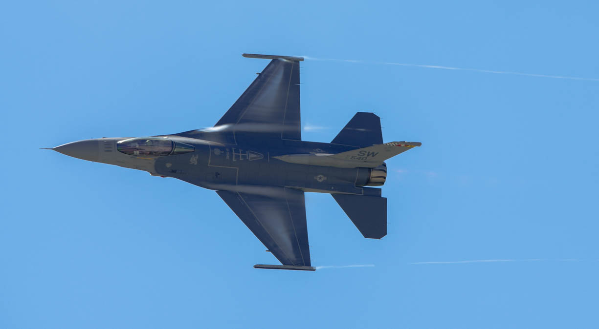 An f-16 going supersonic at an air show