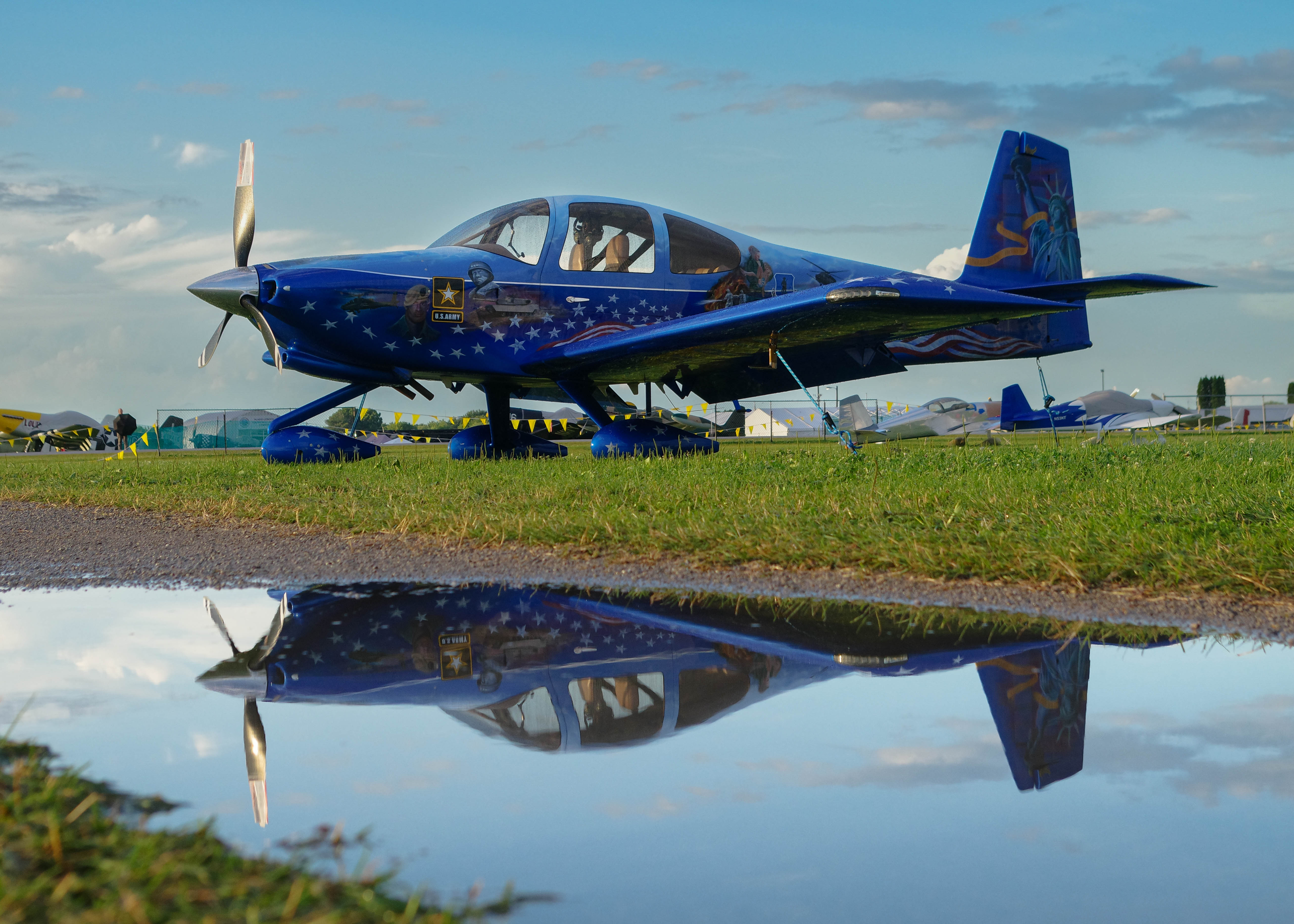 A red Ferrari 296 GT3 racing into the night at the 2023 IMSA 8 Hours at Indy during October.