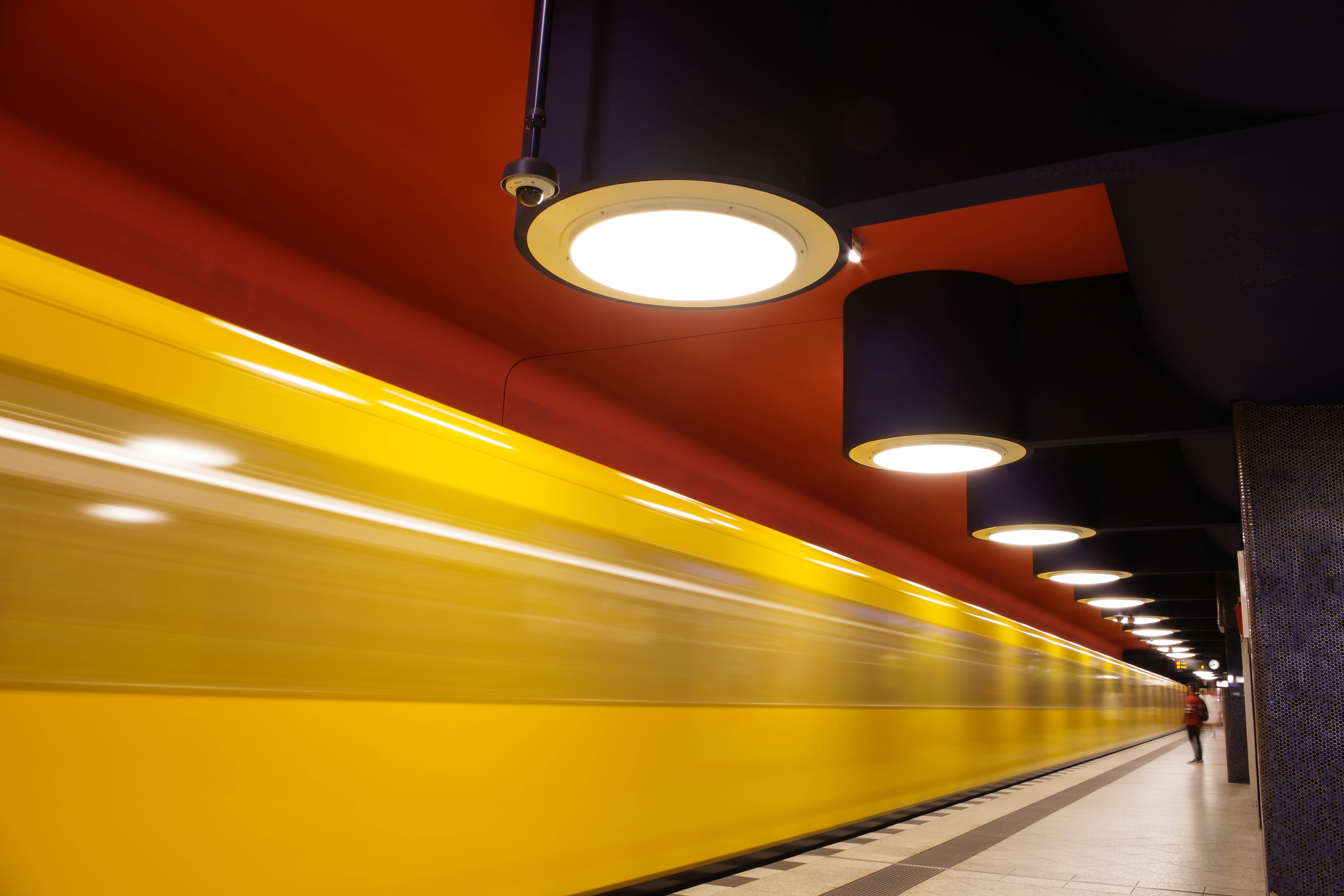This image shows the American side of Niagara Falls at night. This image was captured from the Canadian side in Niagara Falls, Canada. This scenic location is a popular tourist attraction, especially at night because of the scenic light show that occurs every night at the falls. In this image of the falls, the waterfall is blue and orange because of lights that illuminate the falls from behind it.