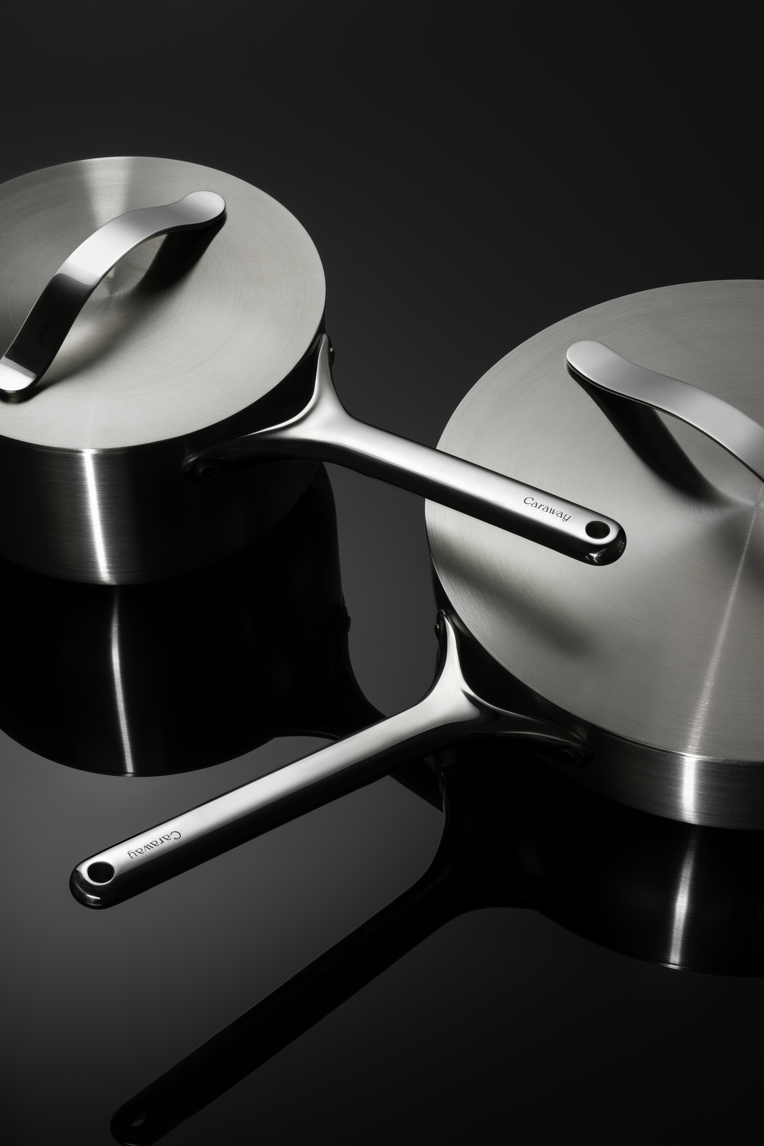 Caraway Stainless Cookware on black background.