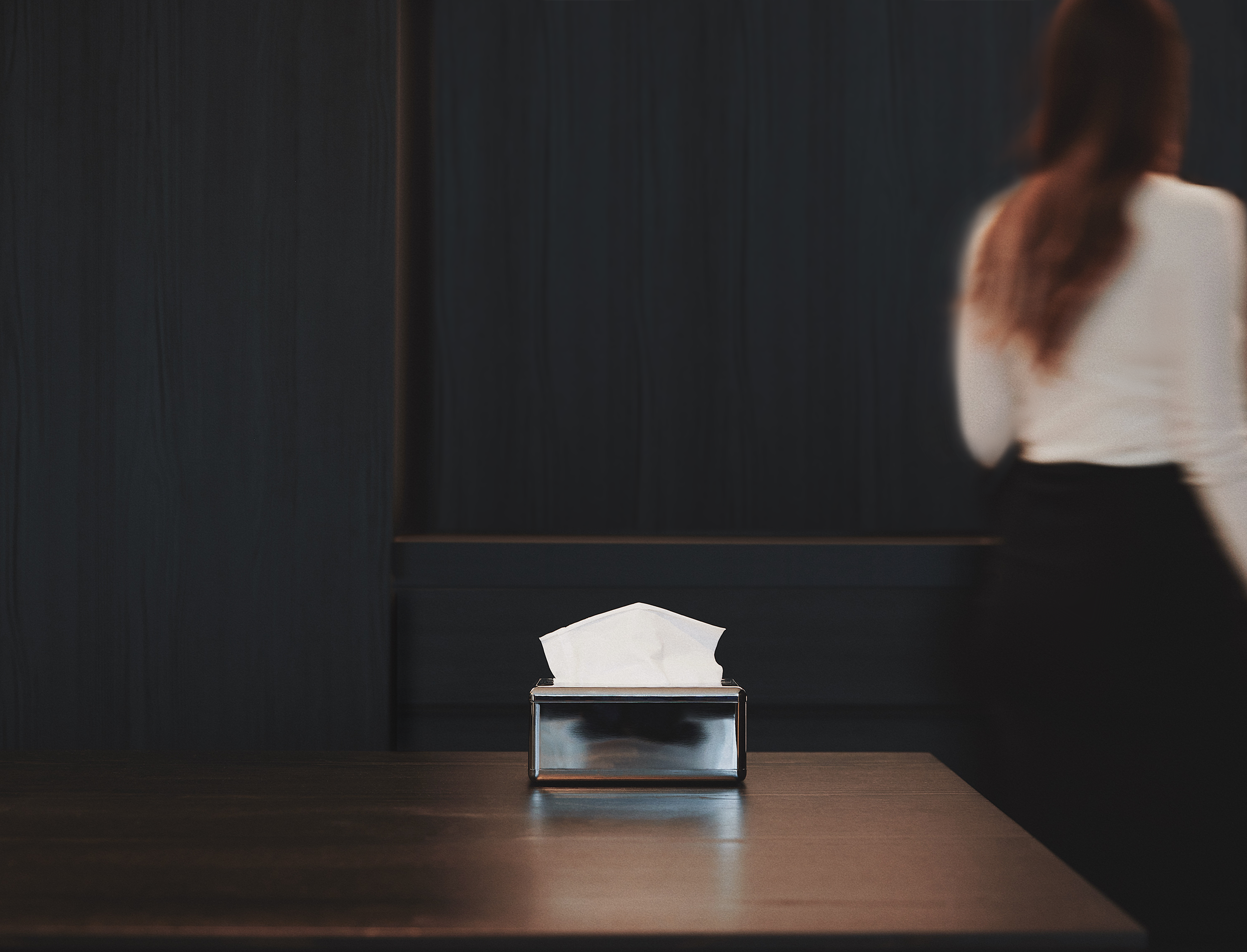 Fox Fold Facial Tissue Dispenser on a table in a dark environment.