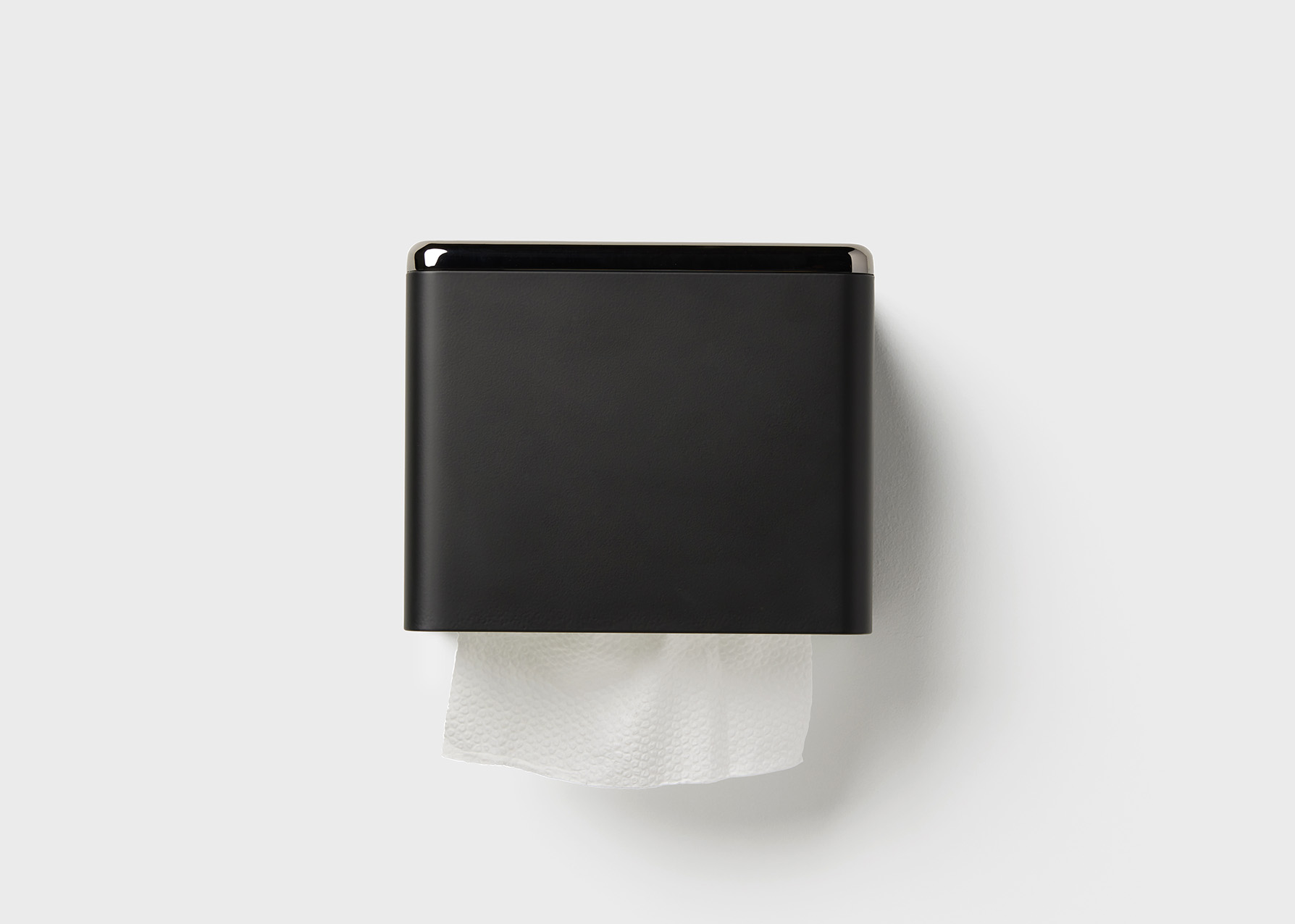 Fox Fold Toilet Paper Dispenser in dark color on wall.