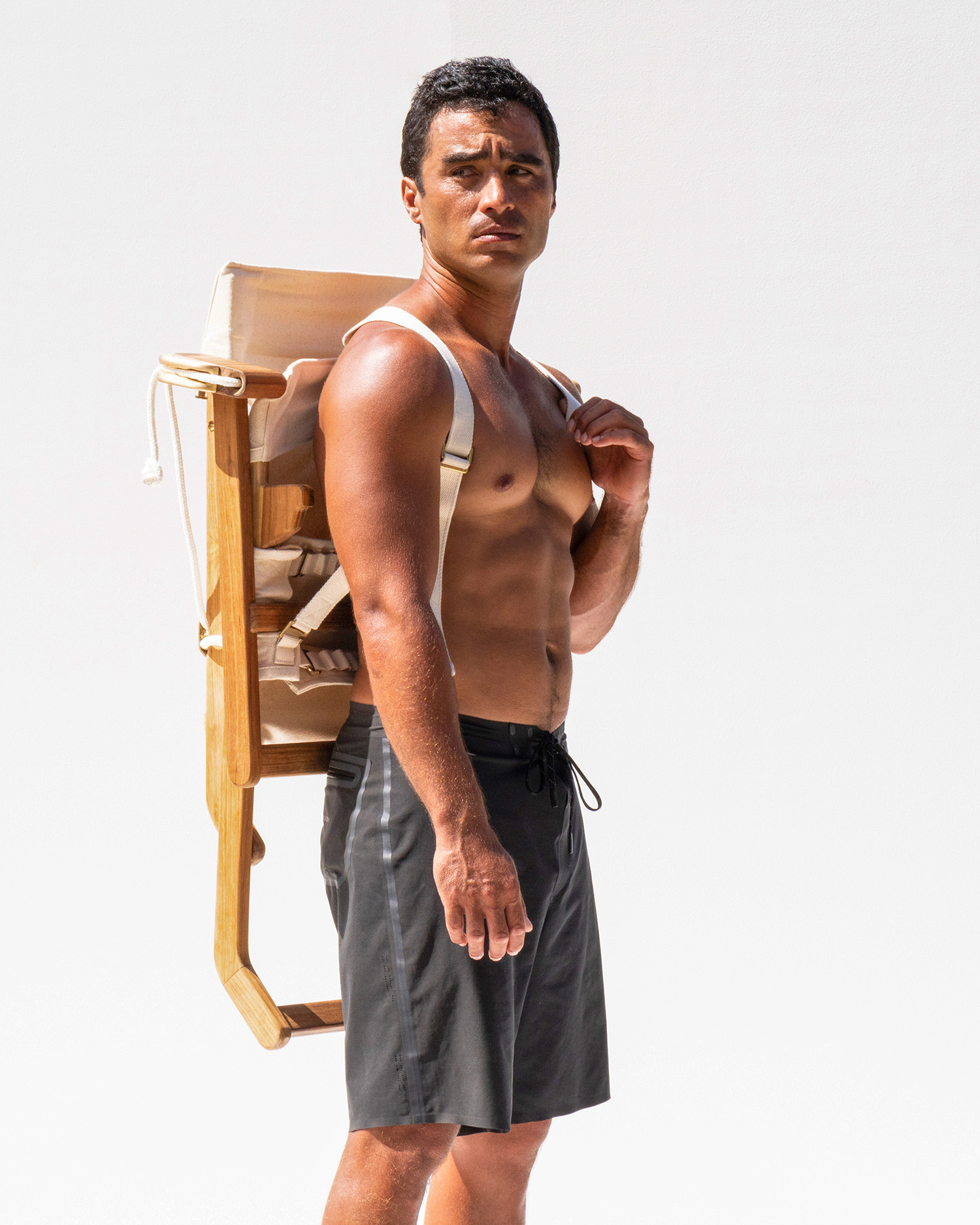 Man carrying Shorebird Chair in backpack form.