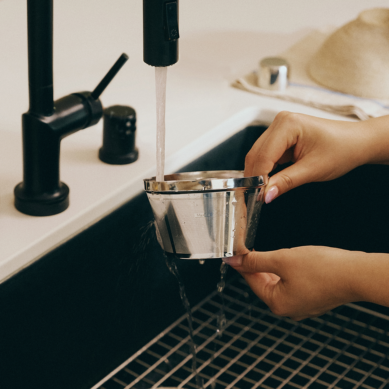Washing the Caraway Coffee Maker Brew Basket.