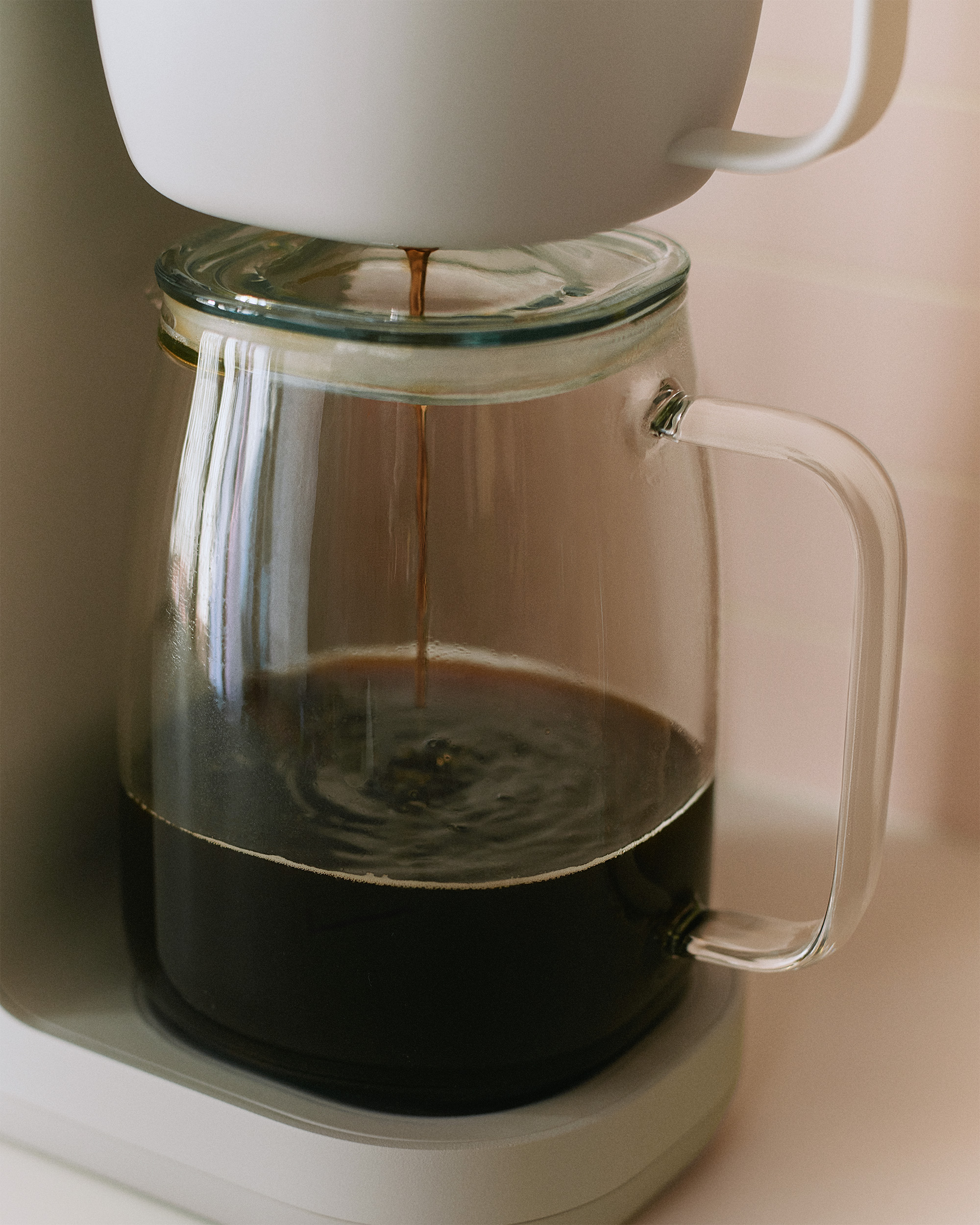 Coffee filling up the Caraway Coffee Maker Carafe.