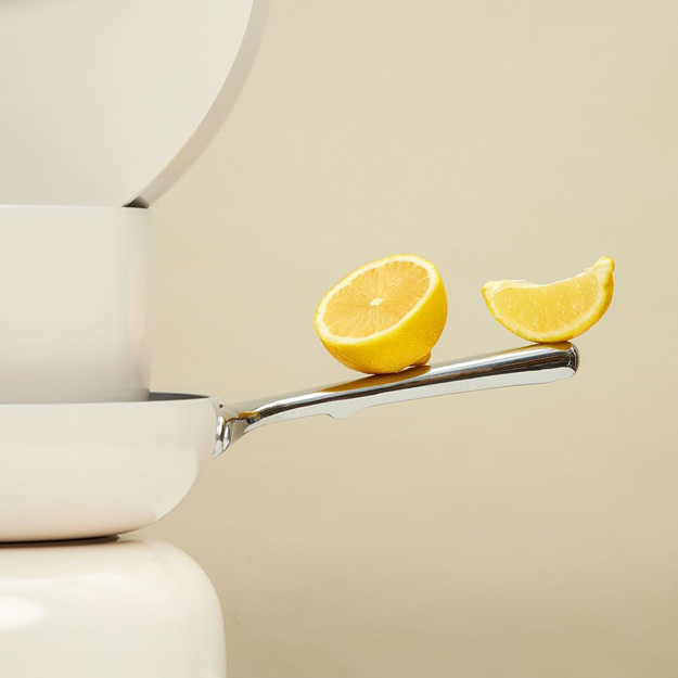 Caraway Cookware lemons balancing on handle
