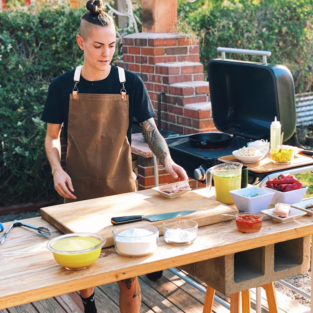 Chef preparing food next to a Spark Grill