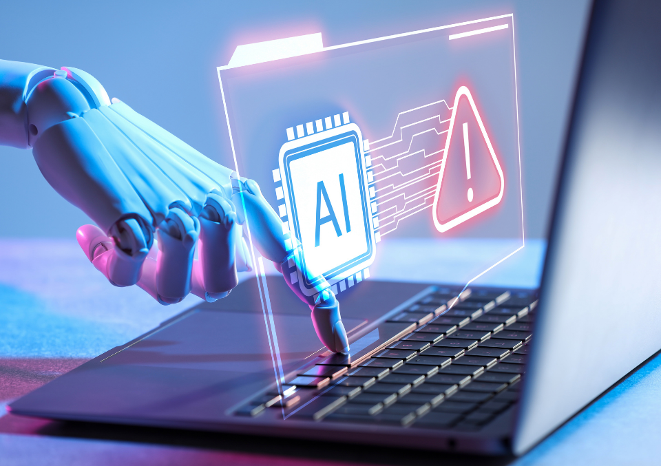 A robotic hand reaching out to press a key on a laptop, interacting with a glowing holographic interface displaying an AI processor icon next to a red warning triangle.
