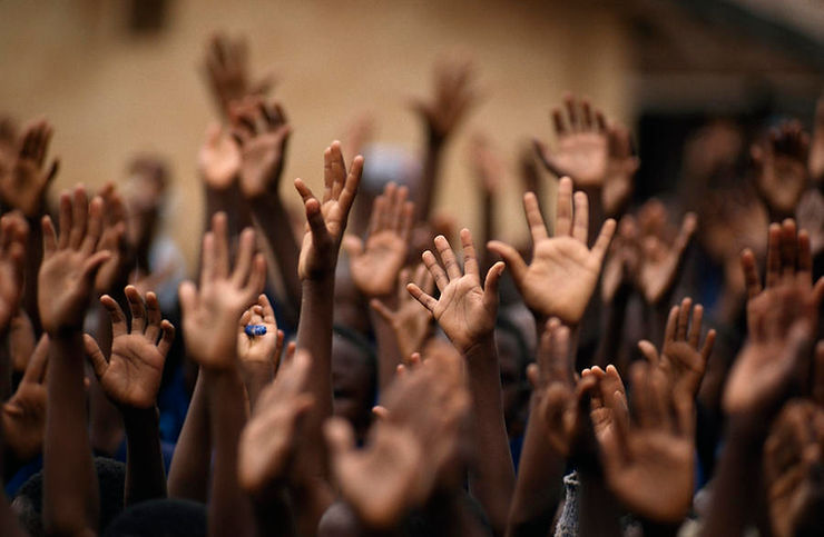 People raising hands to ask question