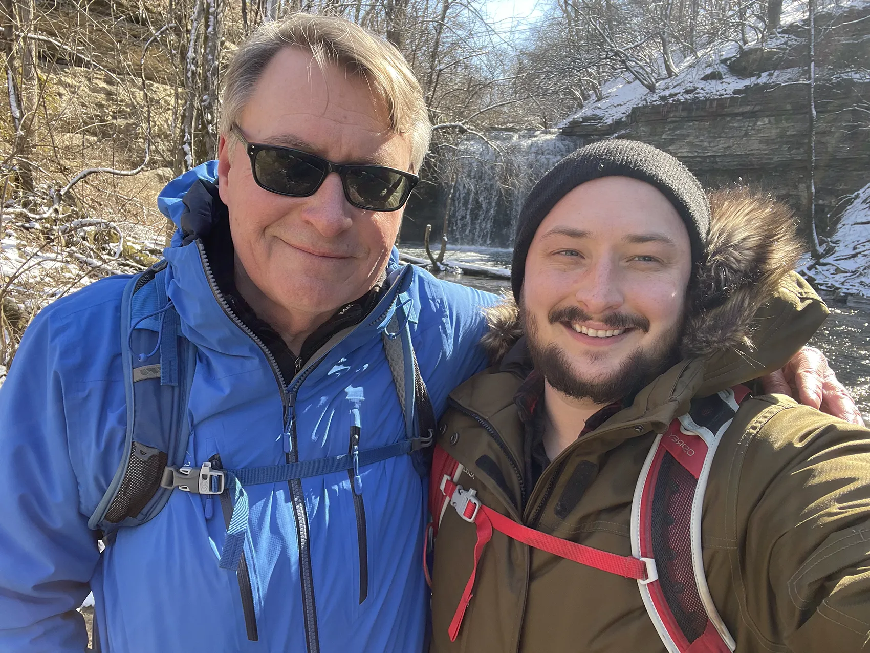Ashton and his dad outdoors during winter season