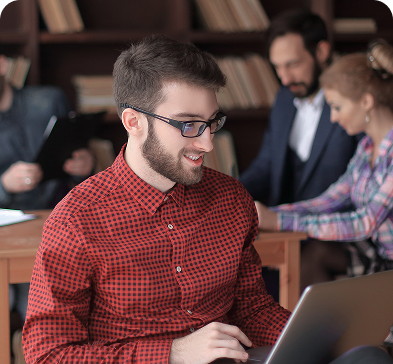 A student happily studying on a laptop