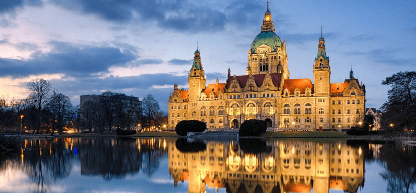 Neues Rathaus in Hannover bei Abenddämmerung mit Spiegelung im Maschteich – repräsentativer Studienort für ein Duales Studium Soziale Arbeit in Hannover an der CBS.