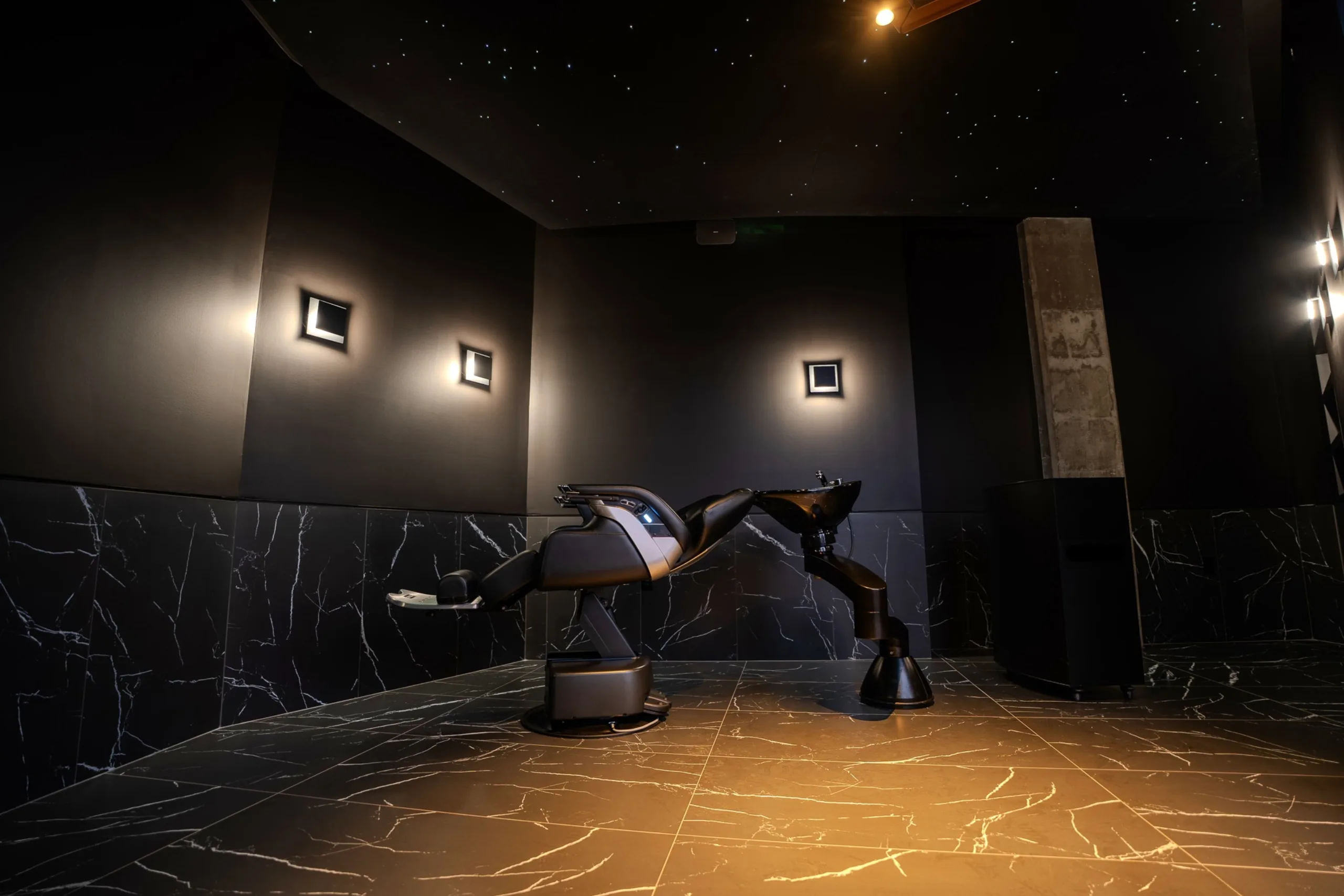 The awarded grooming room, dark marble under a starlit ceiling
