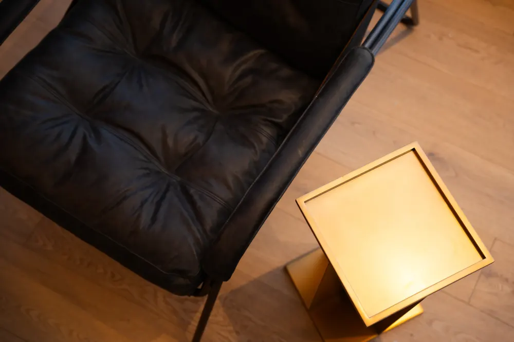 Lounge seating framed by red curtains and brass fixtures