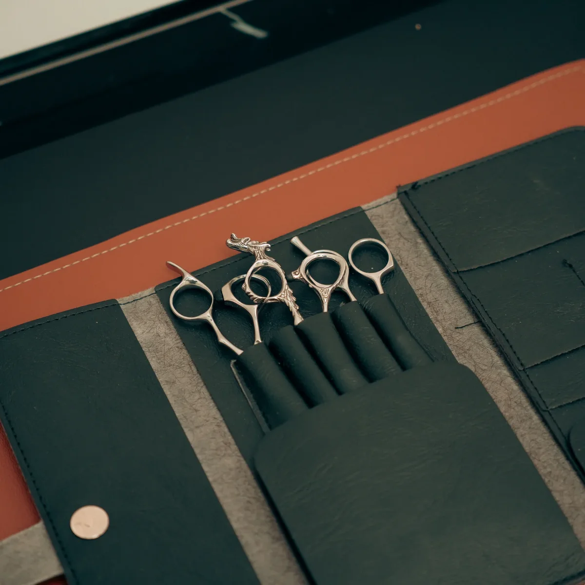 The scissors set in its leather roll