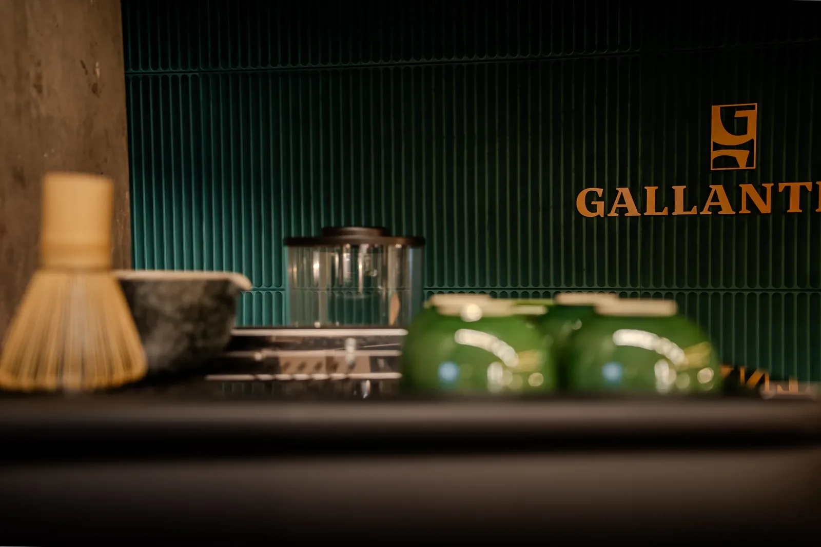Matcha service at the bar beneath the Gallantier wordmark