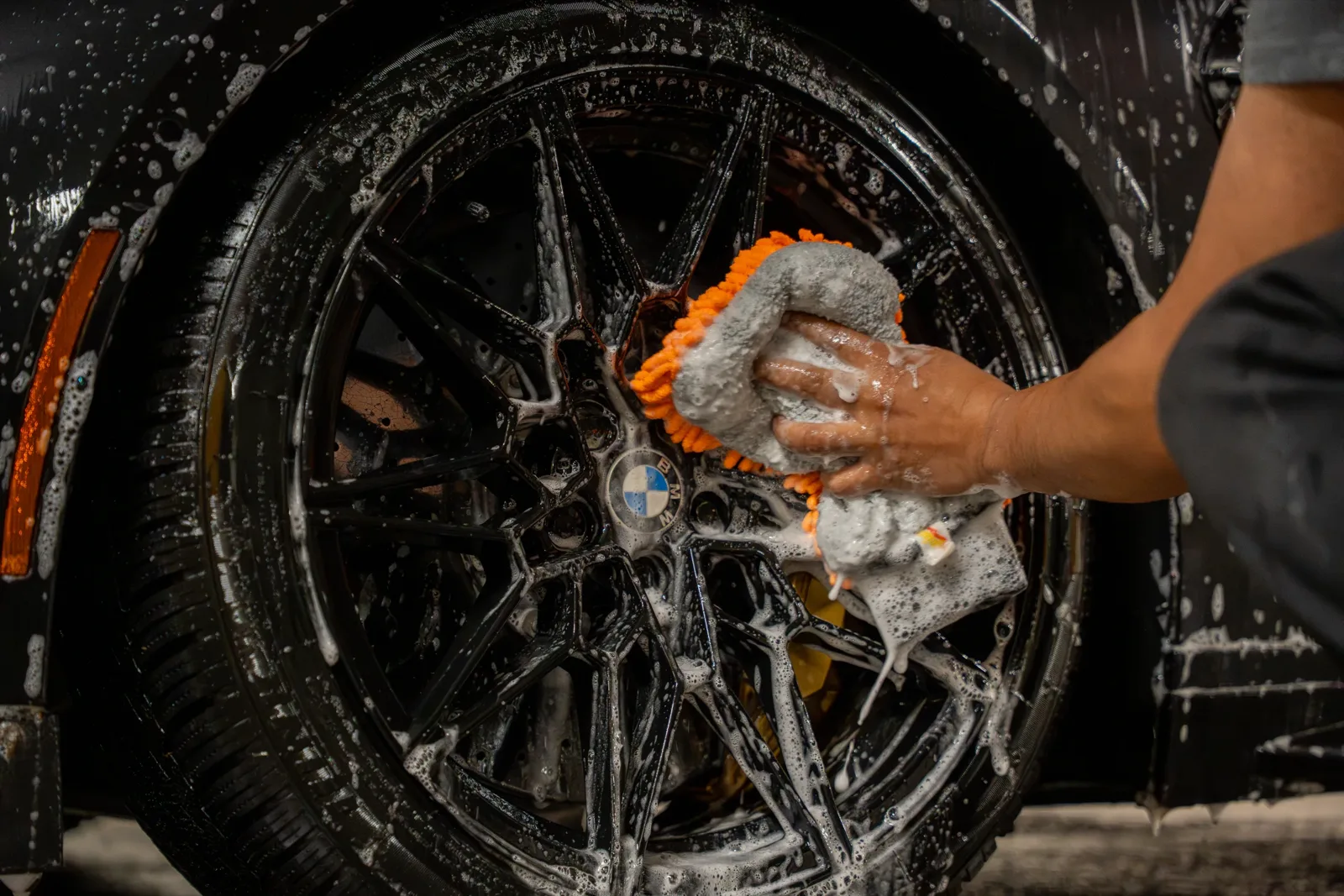 Hand washing a wheel during car care