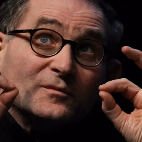 Portrait for Festival dei Due Mondi: Contemplative man with glasses adjusting lens