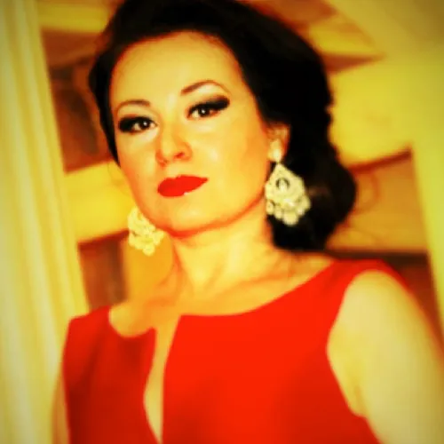 Portrait for Festival dei Due Mondi: Elegant woman in red dress, golden earrings