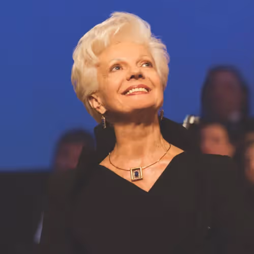 Portrait for Festival dei Due Mondi of smiling senior woman looking up