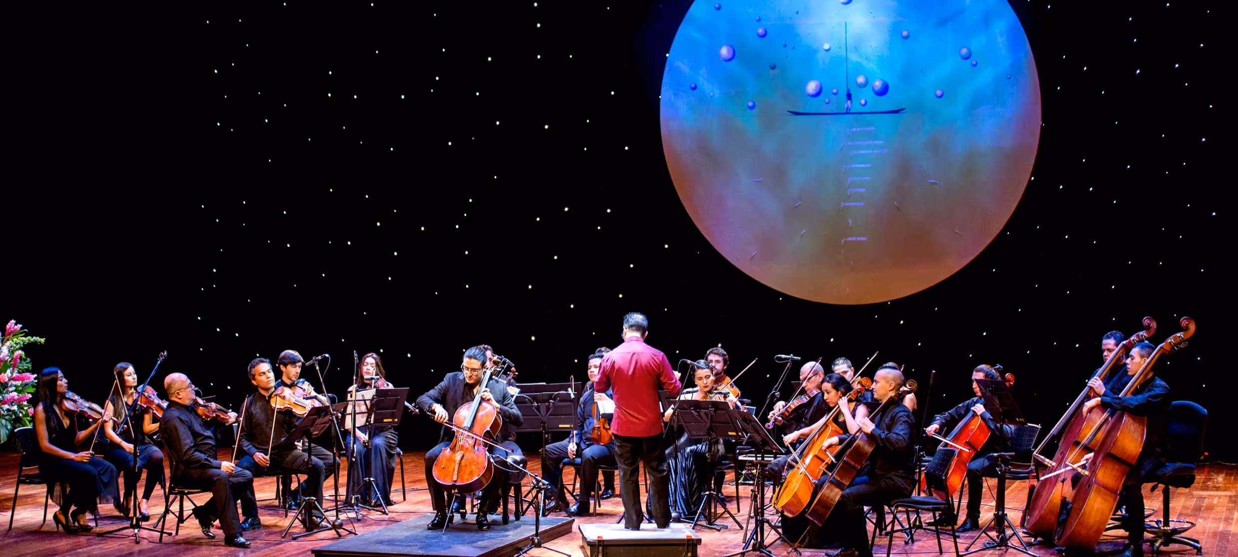 Portrait for Festival dei Due Mondi: Orchestra performing under cosmic sphere