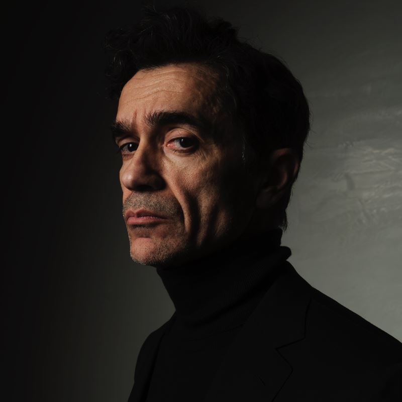 Portrait for Festival dei Due Mondi: dramatic low-key headshot of contemplative man