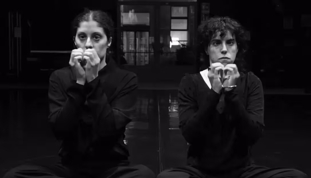 Black and white performers at Festival di Spoleto, creating heart gestures