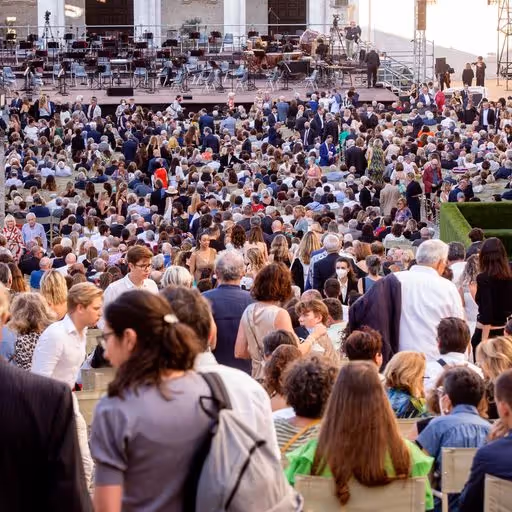 Crowded outdoor venue at Festival di Spoleto with audience seated for performance