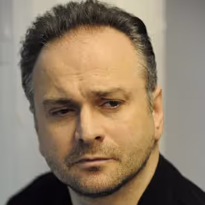 Artist portrayal at Festival di Spoleto, contemplative expression against neutral background