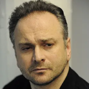 Artist portrayal at Festival di Spoleto, contemplative expression against neutral background