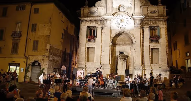 Nighttime musical performance at Festival di Spoleto in historic Italian square