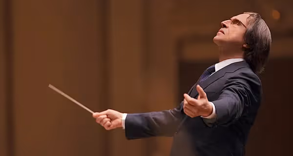 Conductor leading orchestra with passion at Festival di Spoleto classical music event