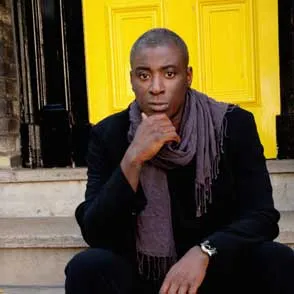 Festival di Spoleto performer in black jacket, thoughtful pose near yellow door