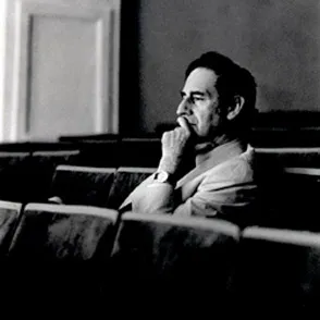 Contemplative artist at Festival di Spoleto, seated thoughtfully in black and white