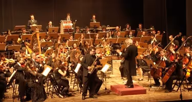 Spoleto Festival di musicians performing classical concert on stage with conductor