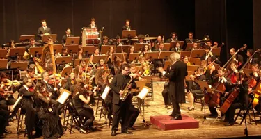 Spoleto Festival di musicians performing classical concert on stage with conductor