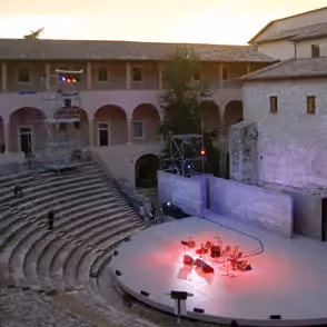 Festival di Spoleto outdoor theater stage with red-lit performance at historic venue