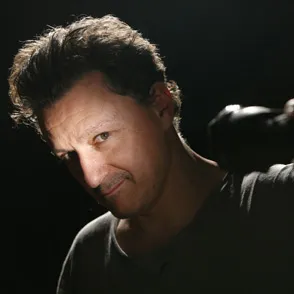 Actor portrait at Festival di Spoleto, dramatic lighting against dark background